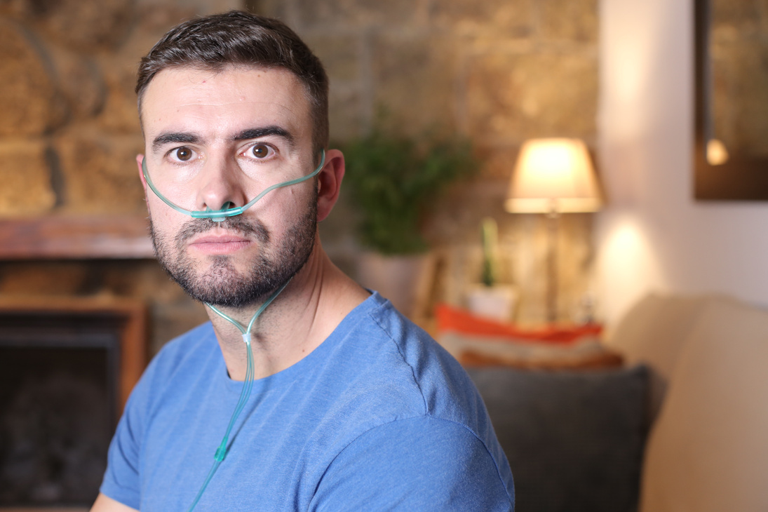 Man receiving oxygen through nasal tube